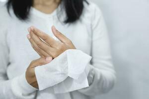 woman using tissue paper Clean your hands to remove germs. photo