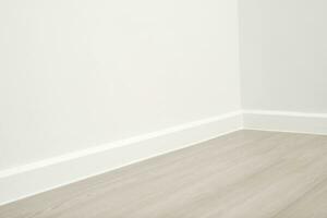 Wooden floors and beautiful white wall-mounted cornices in the house. photo