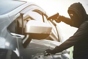 Thieves are using guns to rob a car, threatening a woman with car keys. photo