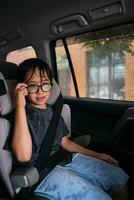 A boy in a car gets wet. photo