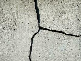 close up cracked concrete wall background photo