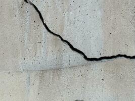 close up cracked concrete wall background photo