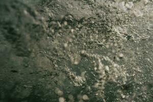 a close up of water splashing on a surface photo