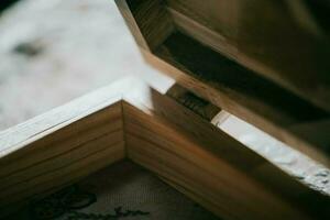 a close up of a wooden box with a small piece of fabric inside photo