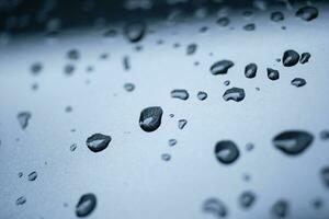 Rain drops cling to the car windshield, selective focus, soft focus. photo