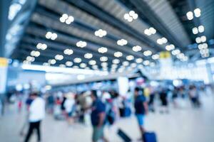 Blurred images of trade fairs in the big hall. image of people walking on a trade fair exhibition or expo where business people show innovation activity and present products in a big hall. photo