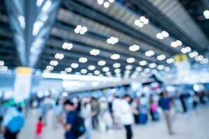 Blurred images of trade fairs in the big hall. image of people walking on a trade fair exhibition or expo where business people show innovation activity and present products in a big hall. photo