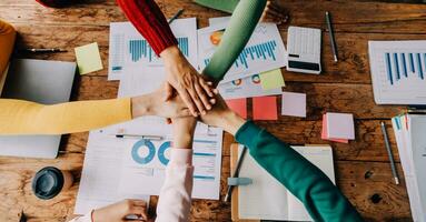 Brainstorming Collaboration and successful partnership analysis by Young business Asian people working in an office workspace photo