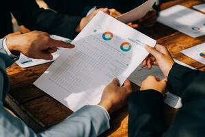 Brainstorming Collaboration and successful partnership analysis by Young business Asian people working in an office workspace photo