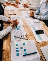 Financial analysts analyze business financial reports on a digital tablet planning investment project during a discussion at a meeting of corporate showing the results of their successful teamwork. photo