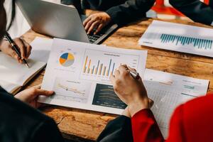 Financial analysts analyze business financial reports on a digital tablet planning investment project during a discussion at a meeting of corporate showing the results of their successful teamwork. photo