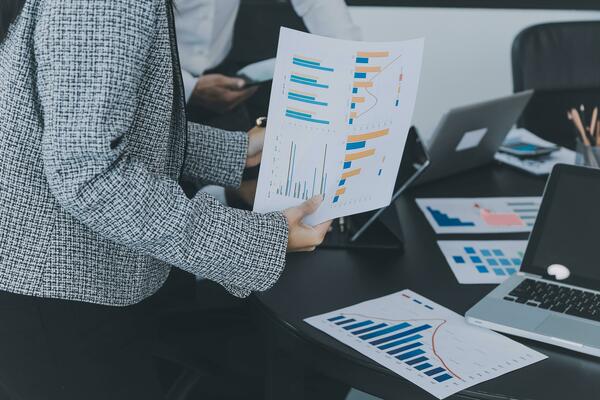 Close up of Business team analyzing income charts and graphs with modern laptop computer. Business analysis and strategy concept.