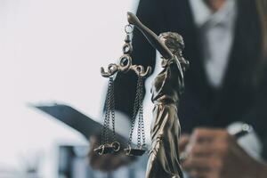 Business and lawyers discussing contract papers with brass scale on desk in office. Law, legal services, advice, justice and law concept picture with film grain effect photo