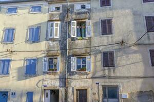 View of an old multi-storey apartment building in need of renovation photo