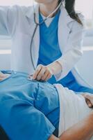 Injured patient showing doctor broken wrist and arm with bandage in hospital office or emergency room. Sprain, stress fracture or repetitive strain injury in hand. Nurse helping customer. First aid. photo