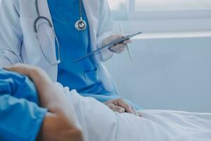 Injured patient showing doctor broken wrist and arm with bandage in hospital office or emergency room. Sprain, stress fracture or repetitive strain injury in hand. Nurse helping customer. First aid. photo