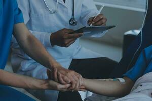 Injured patient showing doctor broken wrist and arm with bandage in hospital office or emergency room. Sprain, stress fracture or repetitive strain injury in hand. Nurse helping customer. First aid. photo