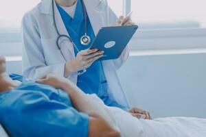 Injured patient showing doctor broken wrist and arm with bandage in hospital office or emergency room. Sprain, stress fracture or repetitive strain injury in hand. Nurse helping customer. First aid. photo