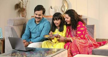 Happy Family Using Laptop And Making Video Call On Raksha Bandhan Festival At Home