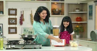 Video of Mother and daughter preparing fruit juice