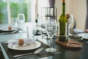 Close-up of wine glasses on the dining table. Including plates and cutlery prepared for customers who will use the service in modern restaurants or hotels. photo