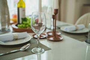 Close-up of wine glasses on the dining table. Including plates and cutlery prepared for customers who will use the service in modern restaurants or hotels. photo