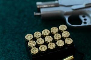 Top view, flat lay of handguns bullets and yellow noise canceling headphones on paper shooting practice target. After shooter practice shooting at theshooting range. Sport shooting concept. photo