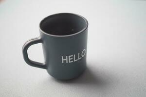 blue coffee cup with hello word photo