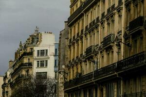 a street in paris with buildings and balconies photo