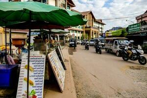 a street with a lot of vendors selling food and drinks photo