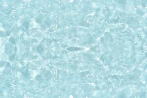 Defocus blurred transparent blue colored clear calm water surface texture with splashes reflection. Trendy abstract nature background. Water waves in sunlight with copy space. Blue watercolor shine. photo