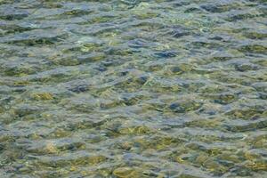 the water is clear and has rocks on the bottom photo