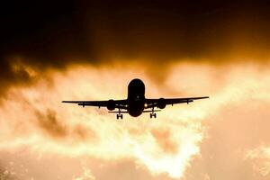 Airplane flying over cloudy sky photo