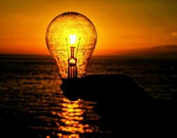 Light bulb and sunset photo