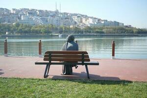 Unhappy girl sitting at bench . photo