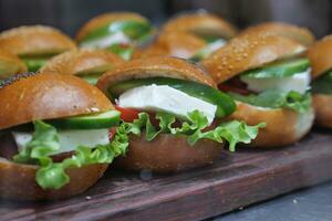 Mini burger with feta cheese, tomato and cucumber lined up at shop photo