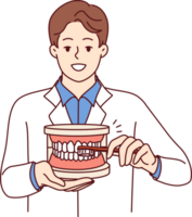 Man dentist explaining rules of brushing teeth, holding toothbrush and giant jaw in hands png