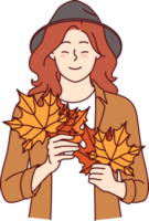 Woman with autumn leaves in hands smiles standing in stylish casual clothes and hat png