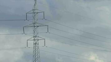 High voltage towers on skies background. Transmission line tower. video