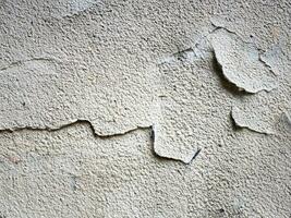 concrete wall with scratches and cracks photo