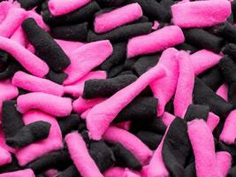 pink and black marshmallows or cotton candies background photo