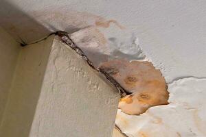 Water damaged ceiling  roof in an old abandoned house. photo