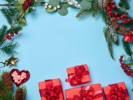 Christmas decor, gifts wrapped in red paper on a blue background, top view. photo