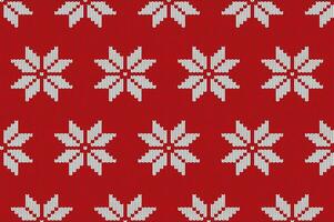 Christmas hand-knitted red vector snowflake seamless pattern. Winter sweater texture.