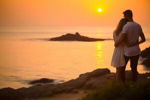 Caucasian couple hugging each other at beach during sunset photo