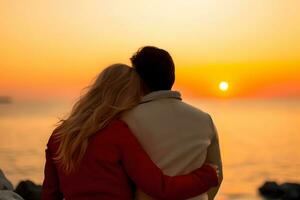 Caucasian couple hugging each other at beach during sunset photo