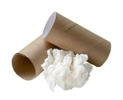 Single white screwed or crumpled tissue paper or napkin in strange shape after use in toilet or restroom with tissue paper cores isolated on white background with clipping path photo