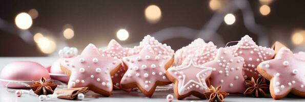 Pink Christmas banner with gingerbread cookies with pink icing and anise stars. Bokeh lights in background. Copy space photo