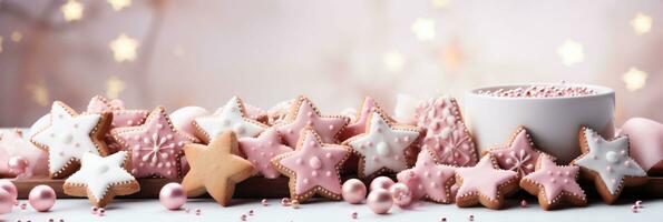 Gingerbread stars with pink glaze on pink Christmas banner, pink sugar pearls on table. photo