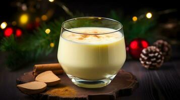 Eggnog with Cinnamon Stick on a Wooden Coaster and Christmas Tree Background photo